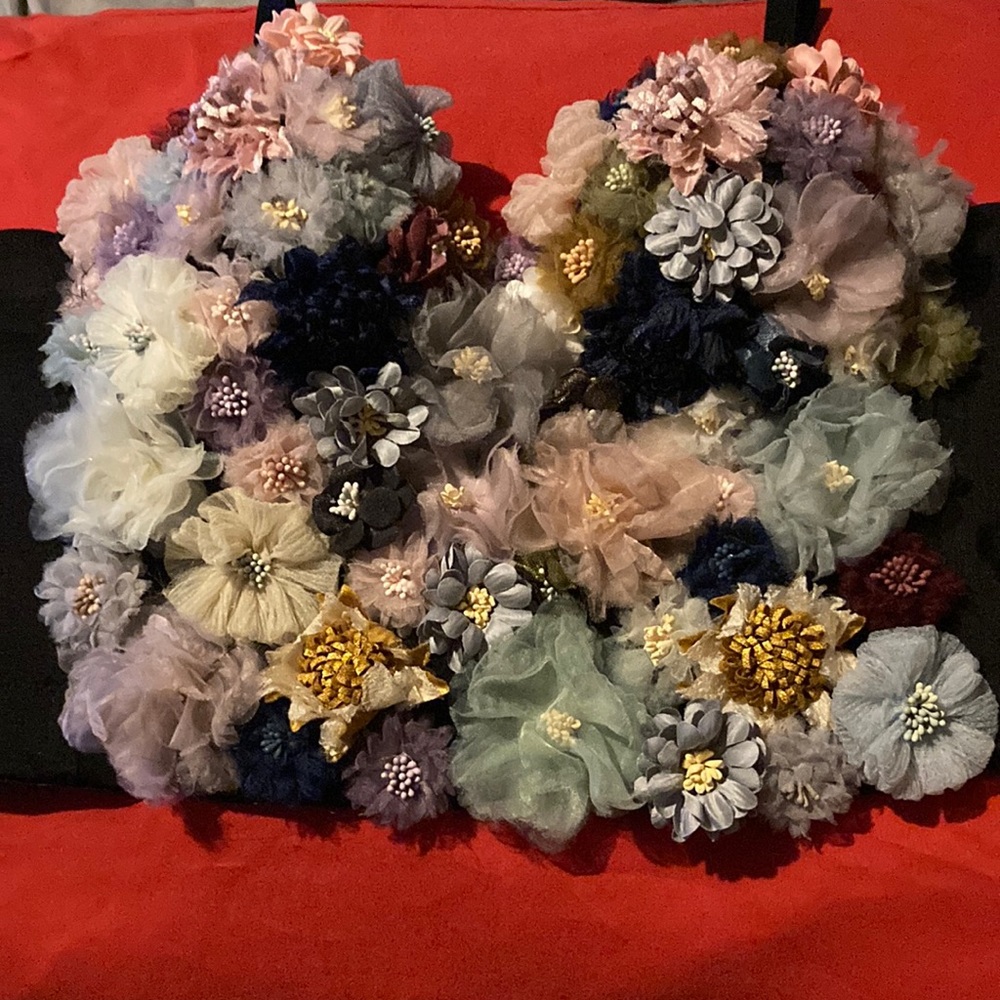 A 3D flower top from AKIRA in a size large and the colors black,pink,blue.